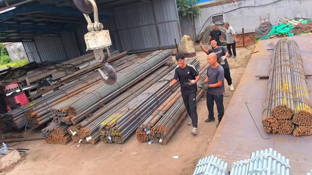 Steel yard workers among bundles