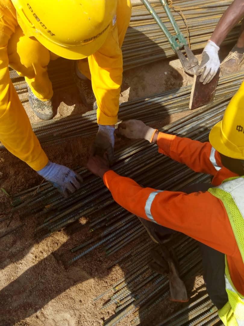 Workers inspecting rebar